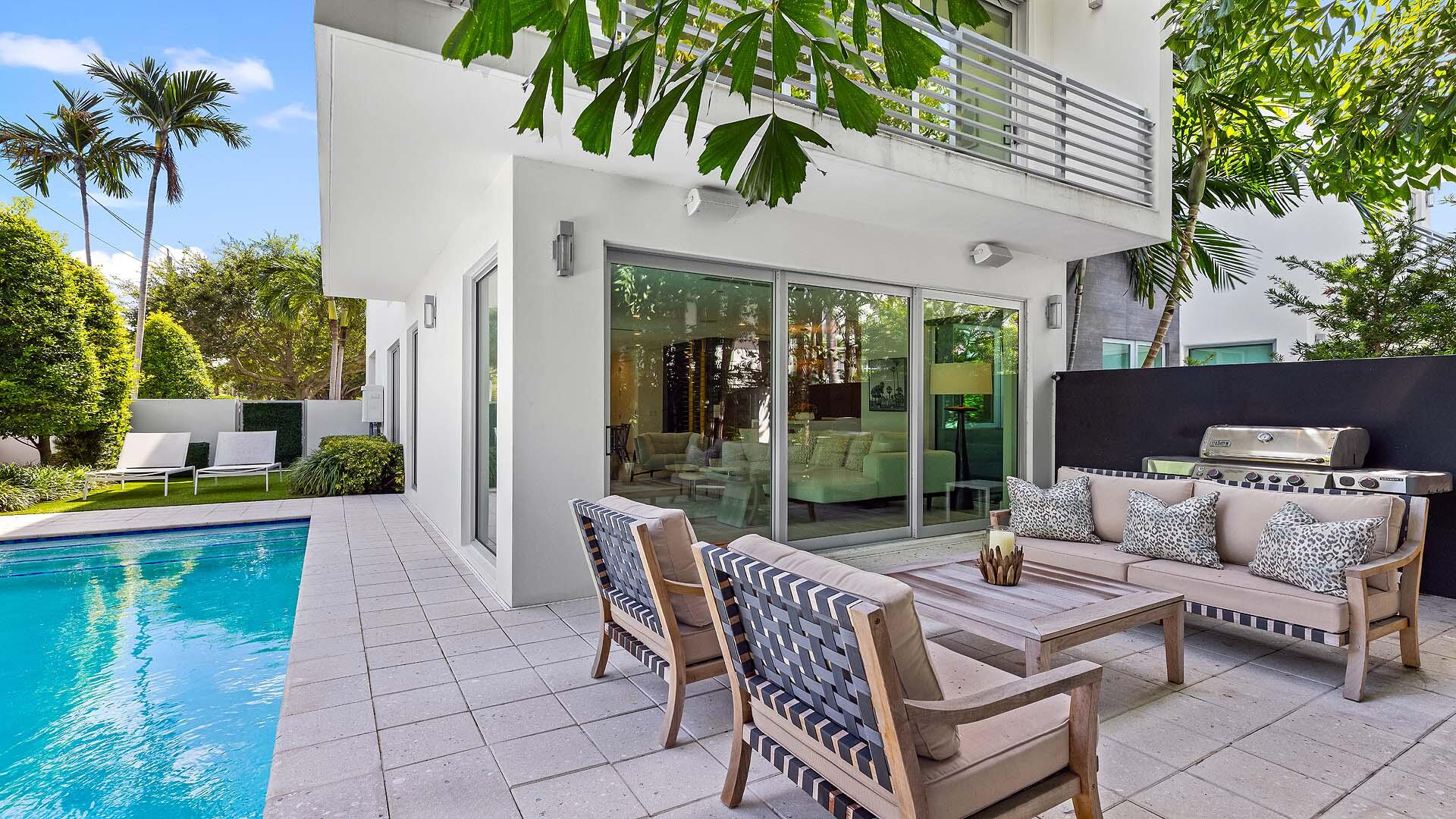 917 Bucida Road, Unit A Delray Beach, FL 33483 - Photo 31 of 36 a view of a patio with couches table and chairs and potted plants