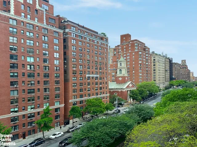 a work room with furniture and paintings on the wall
