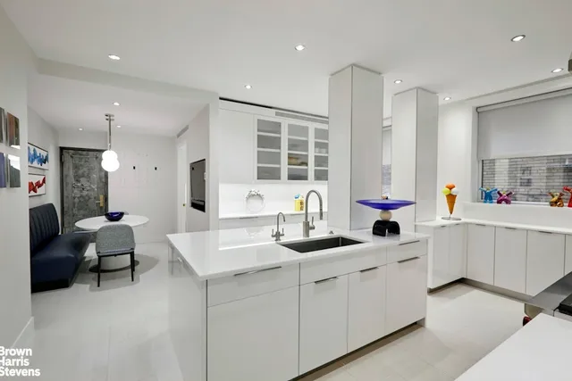 a kitchen that has a sink a stove and a refrigerator