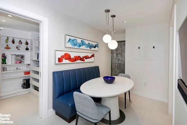 a kitchen with sink and white cabinets