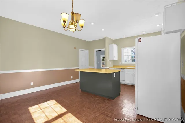 a large kitchen with stainless steel appliances granite countertop a sink and a refrigerator