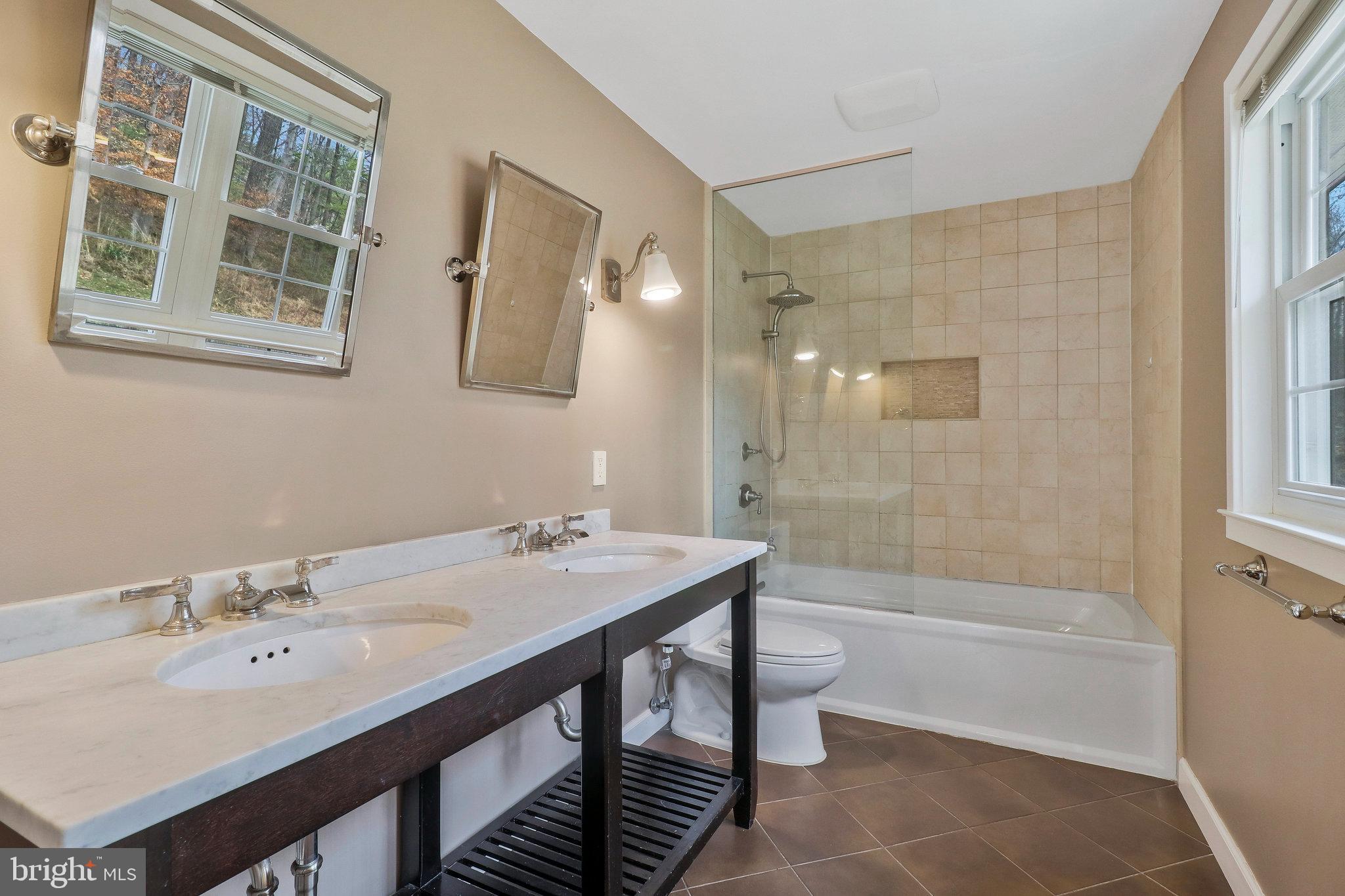 8543 Howell Road Bethesda, MD 20817 - Photo 16 of 24 a bathroom with a sink a toilet and shower