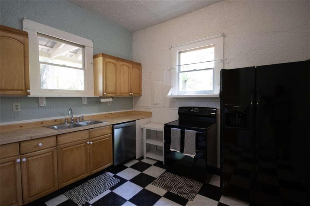285 East Main Street Forsyth, GA 31029 - Photo 12 of 27 a kitchen with stainless steel appliances granite countertop a stove a sink and a microwave
