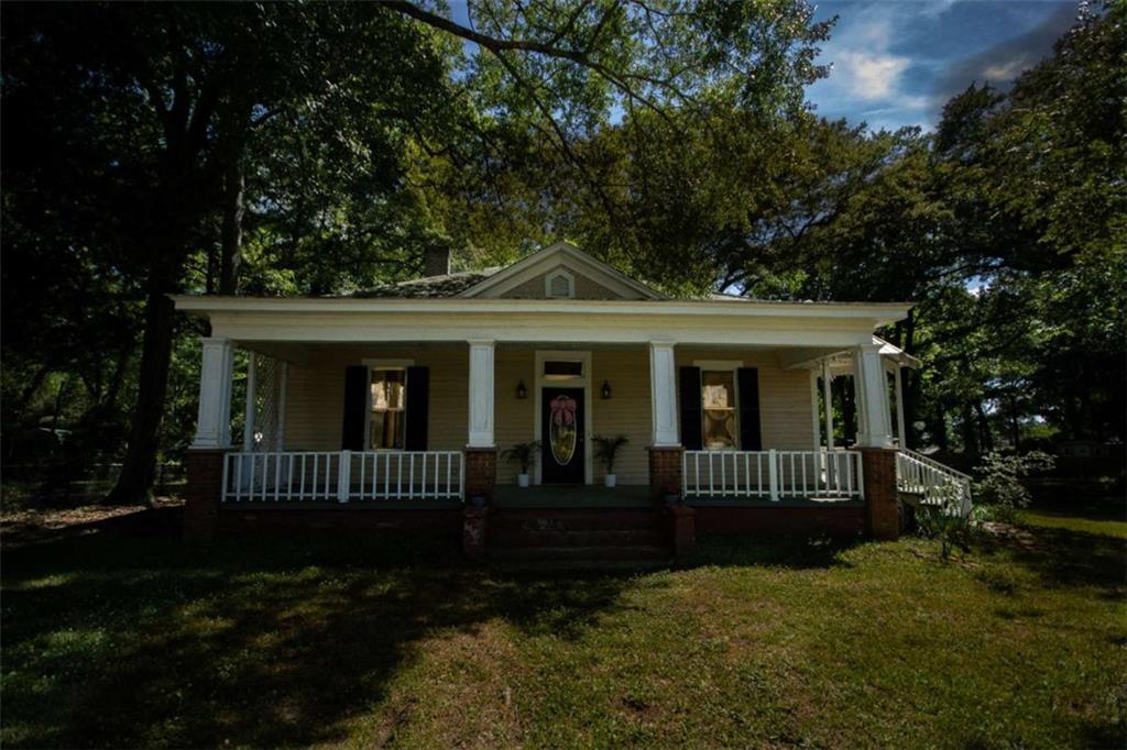 285 East Main Street Forsyth, GA 31029 - Photo 2 of 27 a front view of a house with a garden