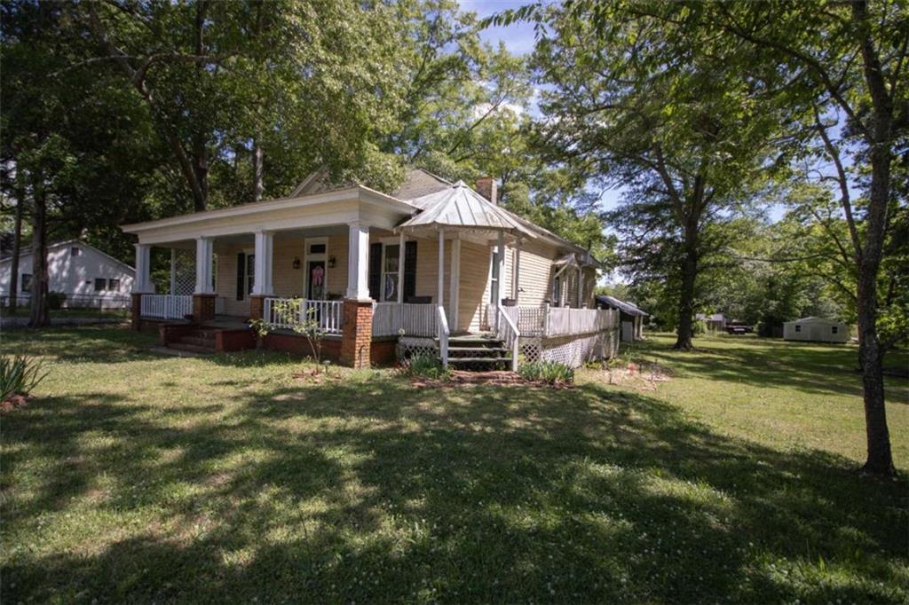 285 East Main Street Forsyth, GA 31029 - Photo 4 of 27 a front view of a house with garden