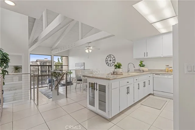 a white kitchen with a sink and cabinets