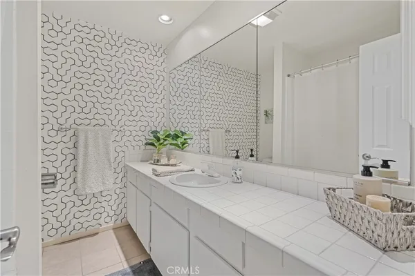 a bathroom with a double vanity sink and a mirror