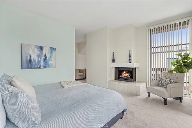 a bedroom with a bed and a fireplace
