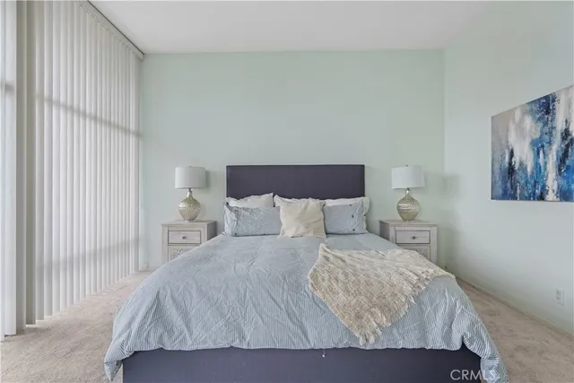 a bedroom with a bed and painting on the wall