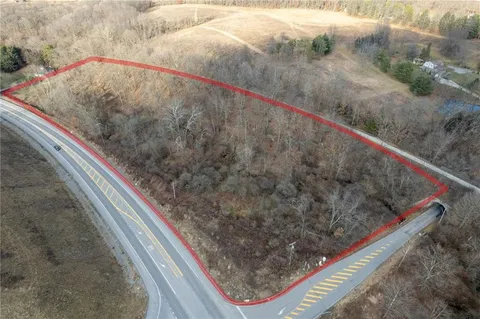 a view of wooden fence and two potted plants