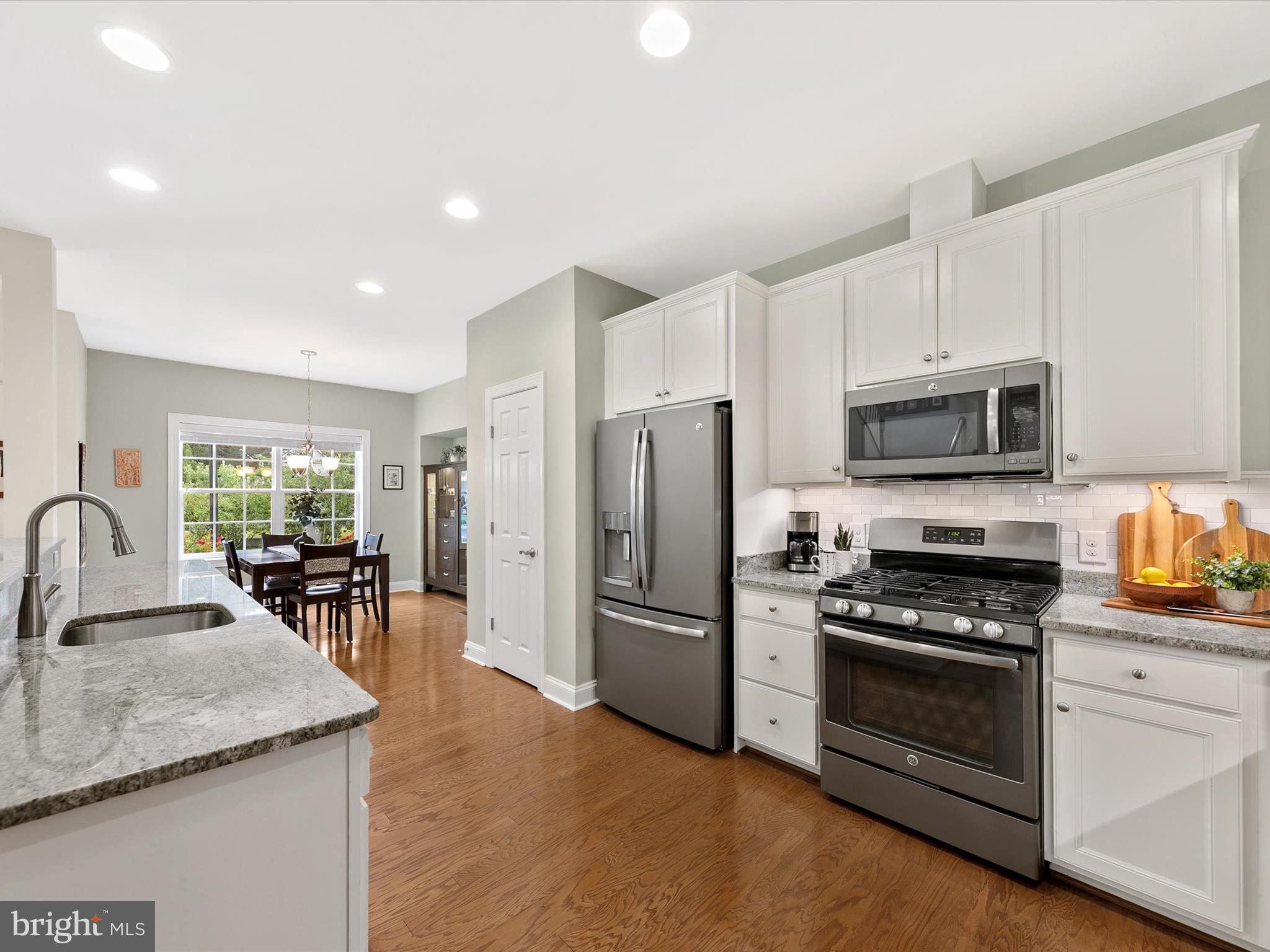 303 Valley Road Milton, DE 19968 - Photo 11 of 72 a kitchen with granite countertop appliances cabinets and chairs