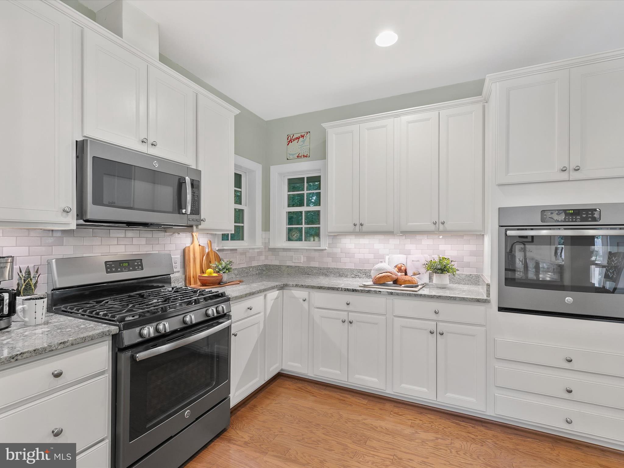 303 Valley Road Milton, DE 19968 - Photo 12 of 72 a kitchen with granite countertop white cabinets stainless steel appliances and a sink