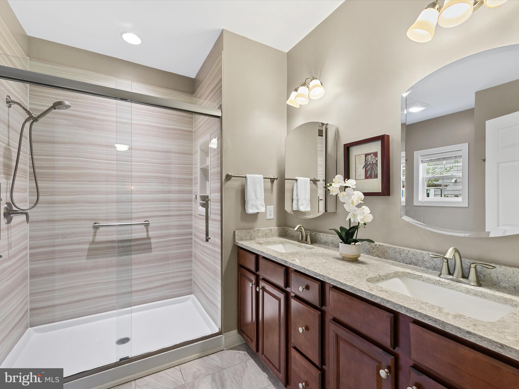 303 Valley Road Milton, DE 19968 - Photo 20 of 72 a bathroom with a granite countertop sink mirror and a shower