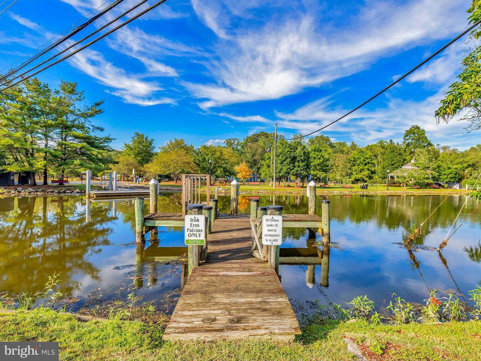 303 Valley Road Milton, DE 19968 - Photo 49 of 72 a view of a lake with boats and trees in the background