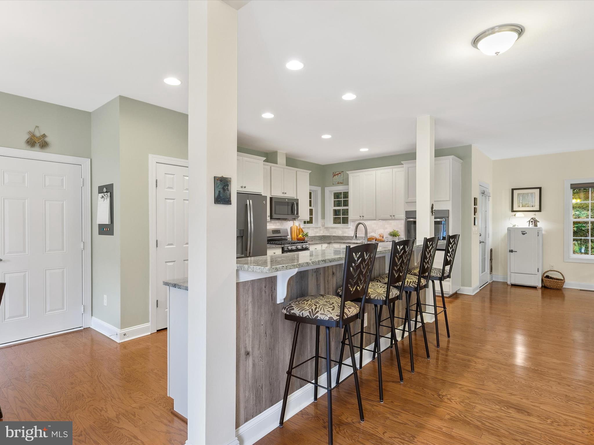 303 Valley Road Milton, DE 19968 - Photo 8 of 72 a view of kitchen dining table chairs and refrigerator
