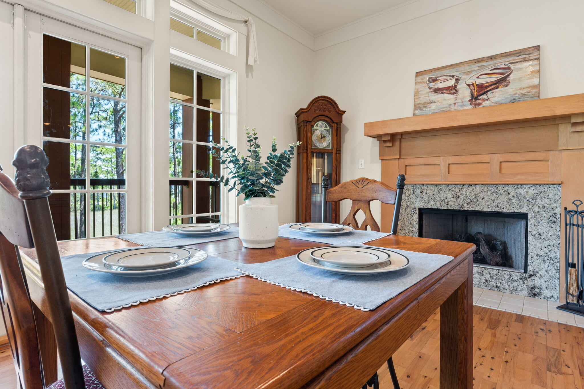 1112 Prospect Promenade, Unit 201 Panama City Beach, FL 32413 - Photo 11 of 43 a dining room with furniture a fireplace and wooden floor