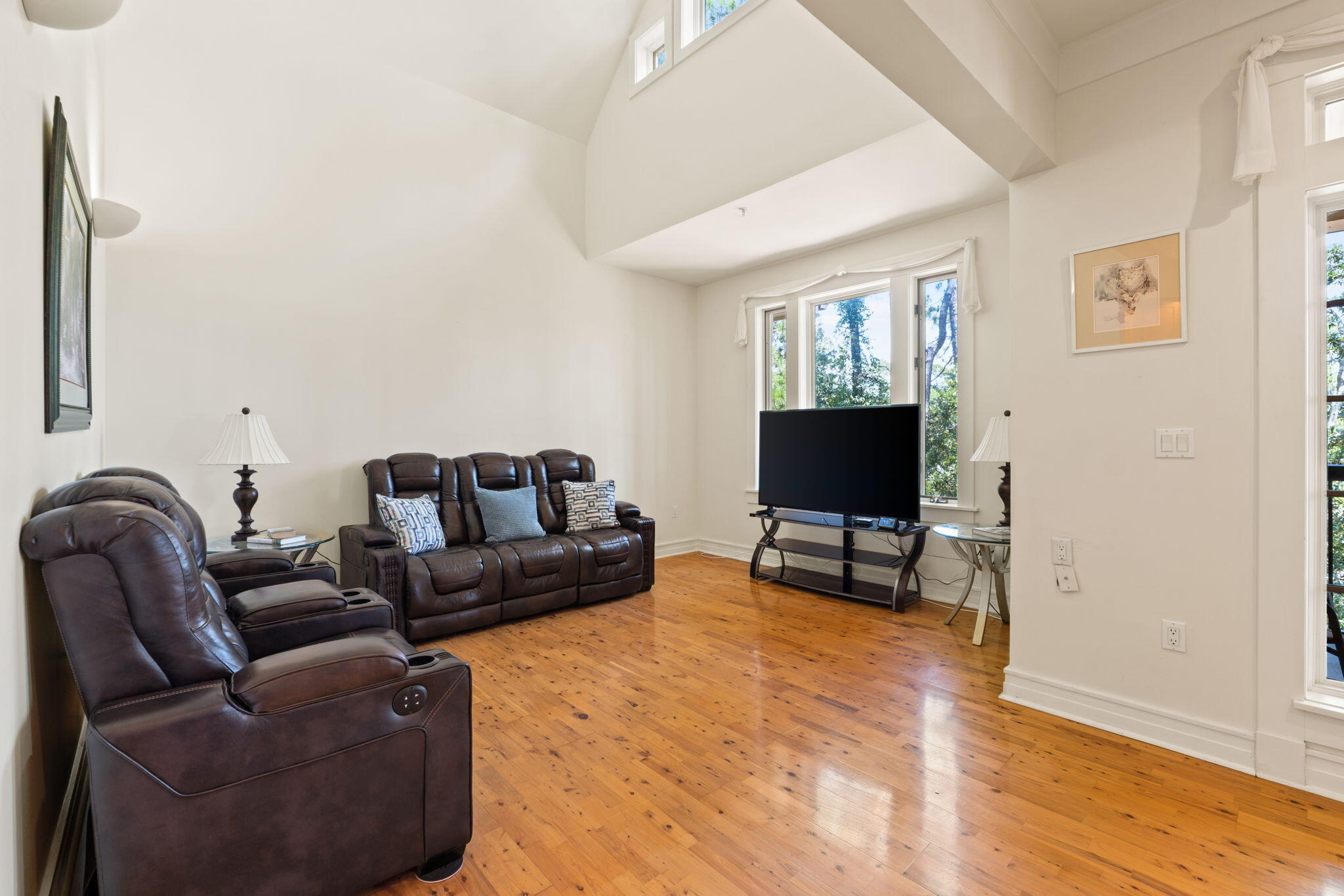 1112 Prospect Promenade, Unit 201 Panama City Beach, FL 32413 - Photo 12 of 43 a living room with furniture and a flat screen tv