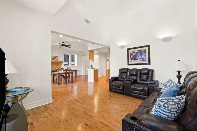 a living room with furniture and wooden floor