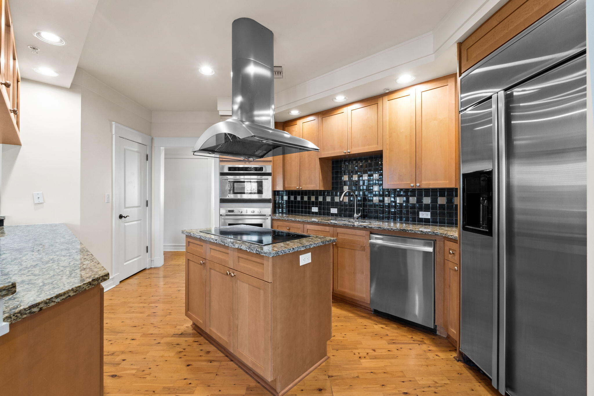 1112 Prospect Promenade, Unit 201 Panama City Beach, FL 32413 - Photo 14 of 43 a kitchen with stainless steel appliances granite countertop a sink a stove and a refrigerator