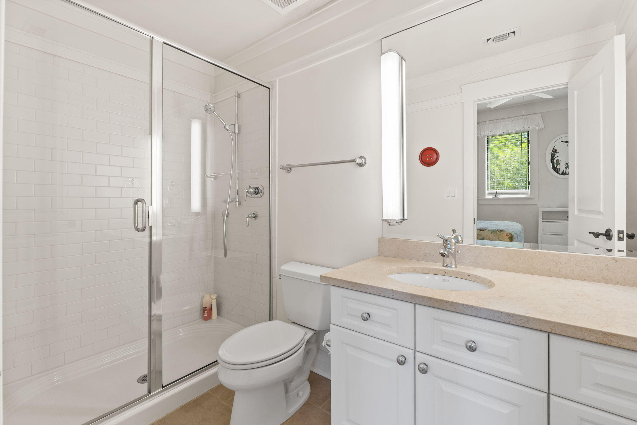 1112 Prospect Promenade, Unit 201 Panama City Beach, FL 32413 - Photo 27 of 43 a bathroom with a shower sink vanity mirror and toilet