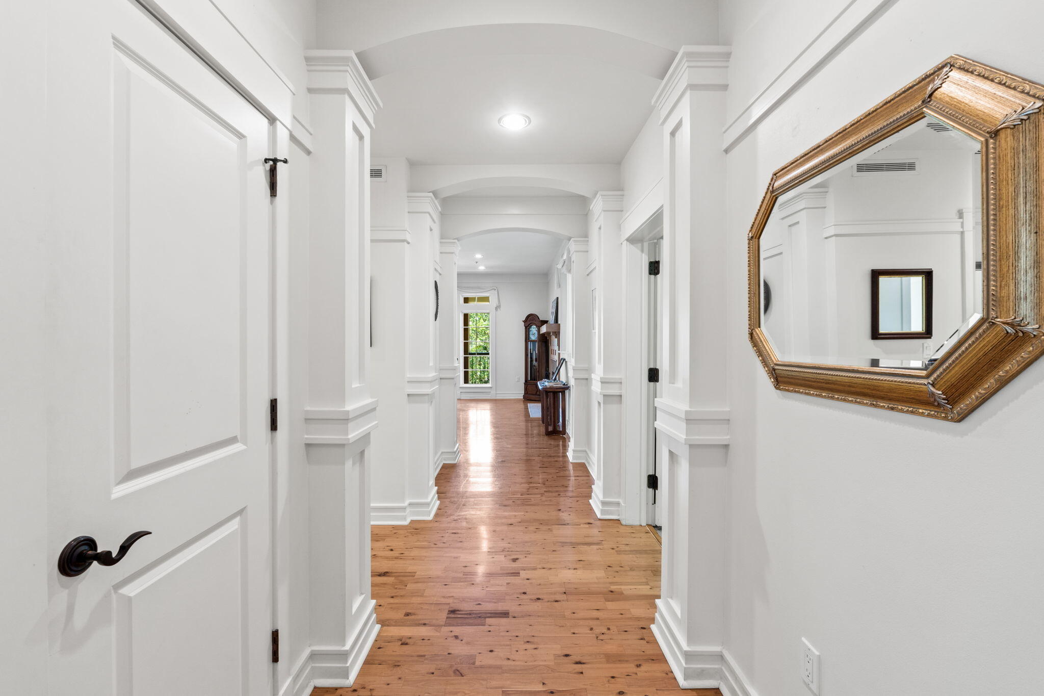 1112 Prospect Promenade, Unit 201 Panama City Beach, FL 32413 - Photo 3 of 43 a view of a hallway with wooden floor and a bathroom