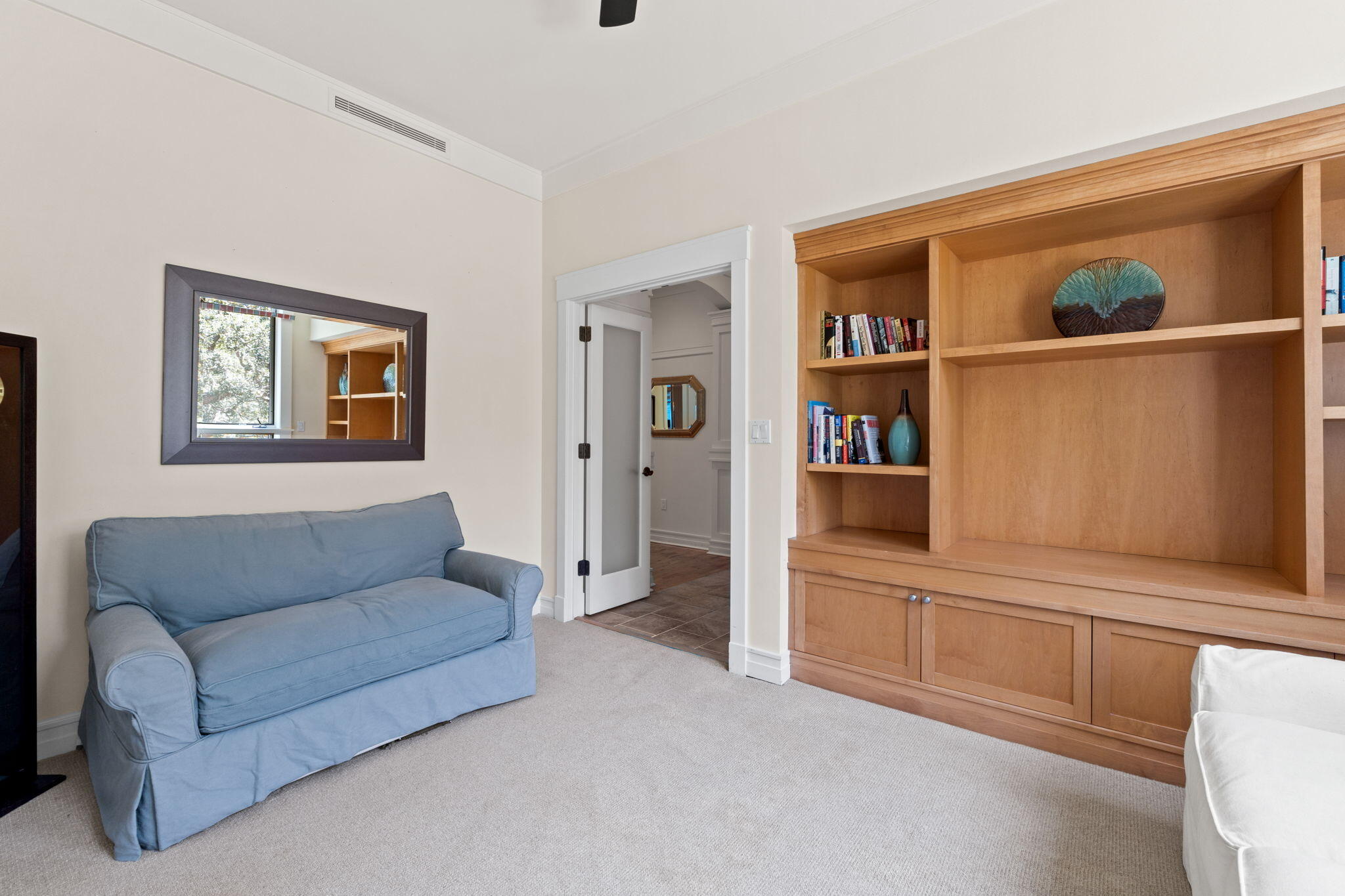 1112 Prospect Promenade, Unit 201 Panama City Beach, FL 32413 - Photo 31 of 43 a living room with furniture and a book shelf