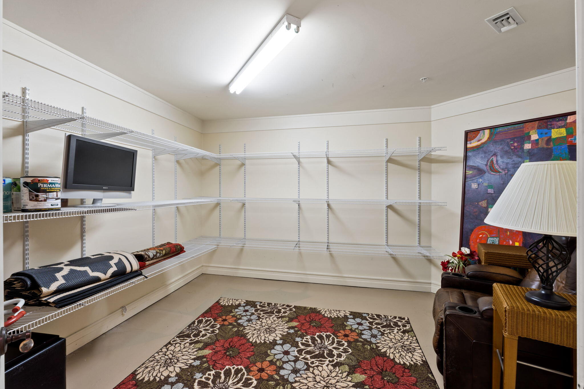 1112 Prospect Promenade, Unit 201 Panama City Beach, FL 32413 - Photo 34 of 43 a room with furniture flat screen tv and appliances