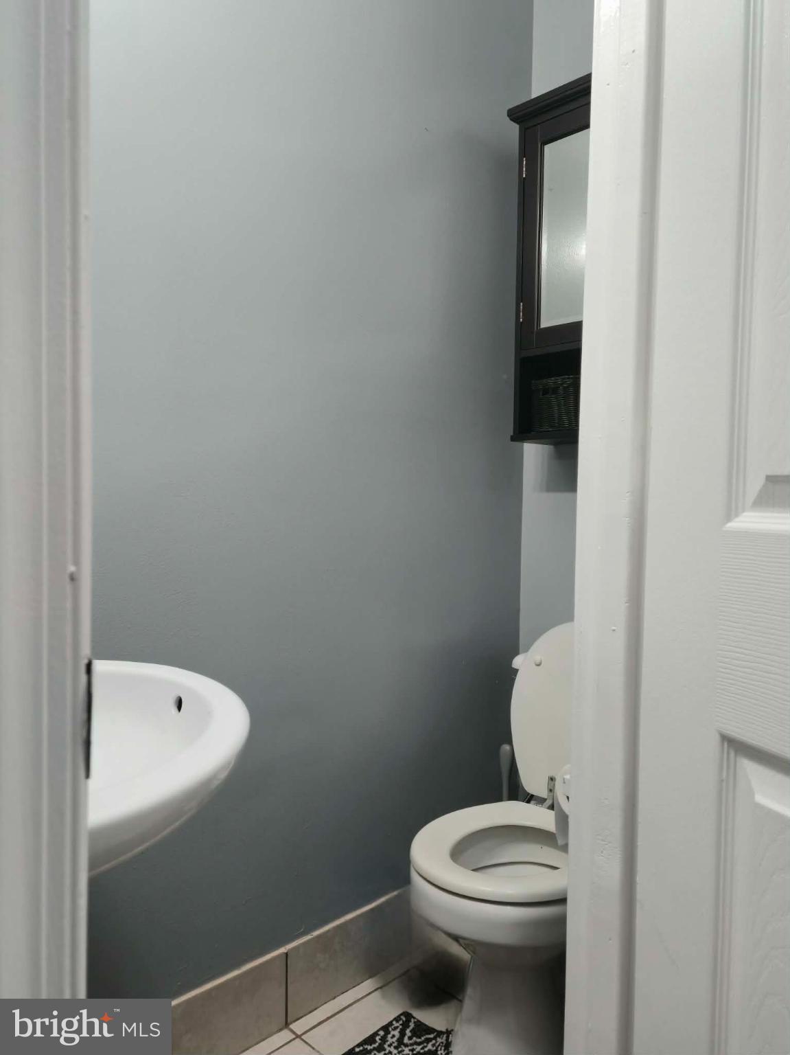 9 Brafferton Way Rosedale, MD 21237 - Photo 21 of 26 a white toilet sitting next to a bathroom sink