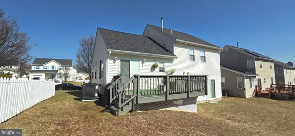 a view of a house with a wooden deck