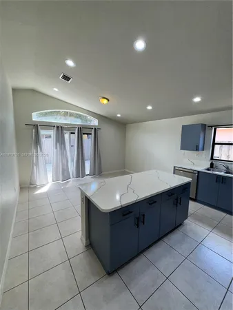 a large kitchen with kitchen island granite countertop a large counter top and oven