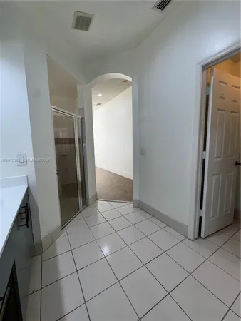 a view of an empty room and closet area