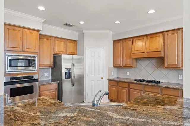 a view of a kitchen with a sink and a fireplace