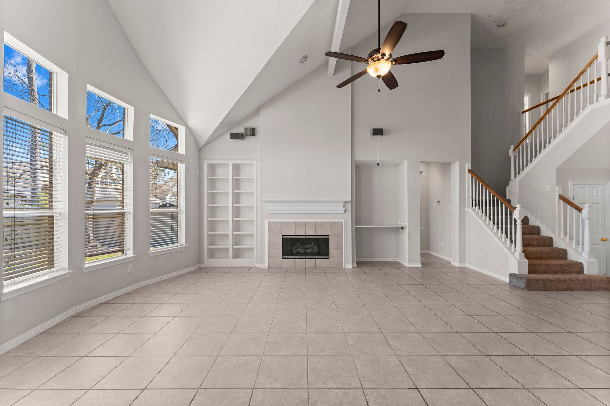 25814 Clear Springs Way Spring, TX 77373 - Photo 21 of 48 a view of an empty room with a fireplace and a ceiling fan