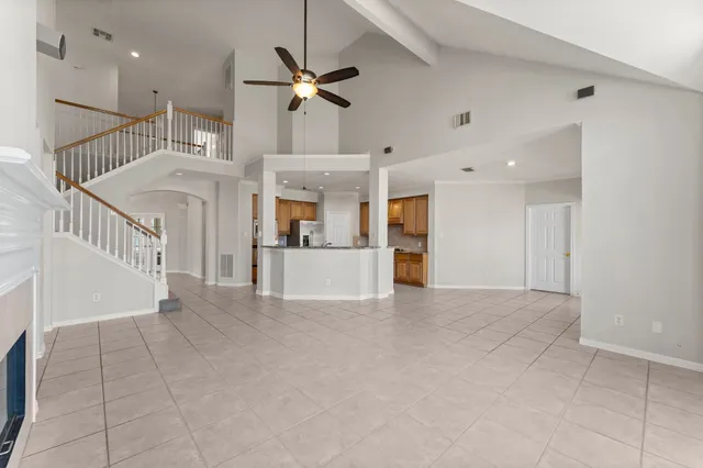 a large kitchen with stainless steel appliances granite countertop a stove and a refrigerator