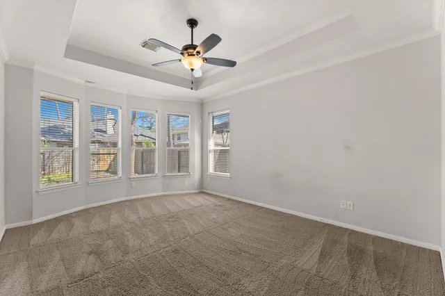 a view of a room with a ceiling fan