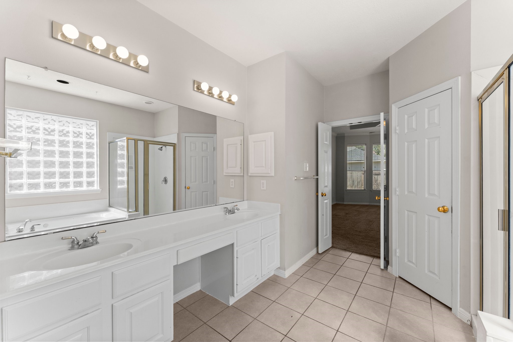 25814 Clear Springs Way Spring, TX 77373 - Photo 32 of 48 a spacious bathroom with a shower a sink and a large mirror