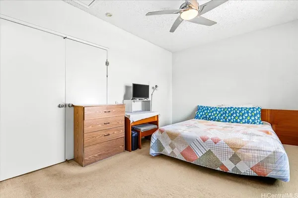 a bedroom with a bed and large window with outer view