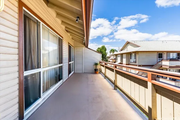 a living room with furniture kitchen view and a chandelier