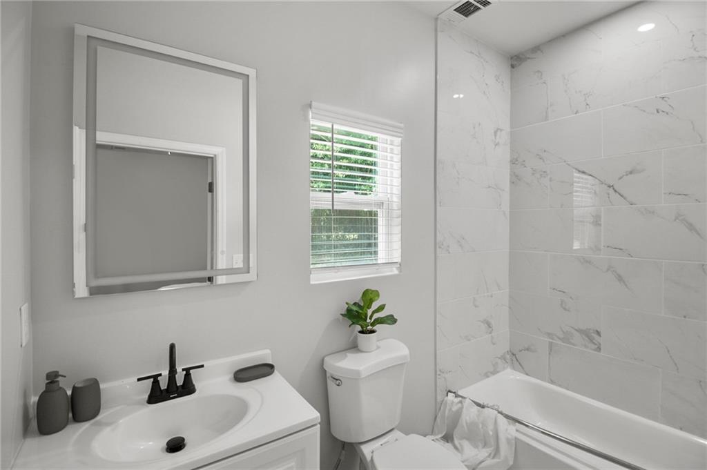 1912 Kitchens Road Macon, GA 31211 - Photo 11 of 20 a bathroom with a sink a toilet and shower