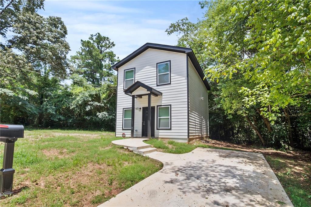 1912 Kitchens Road Macon, GA 31211 - Photo 3 of 20 a front view of a house with a yard and trees