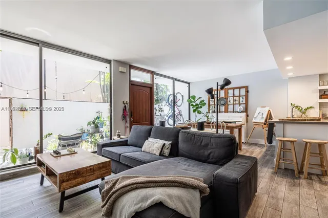 a living room with furniture and a large window