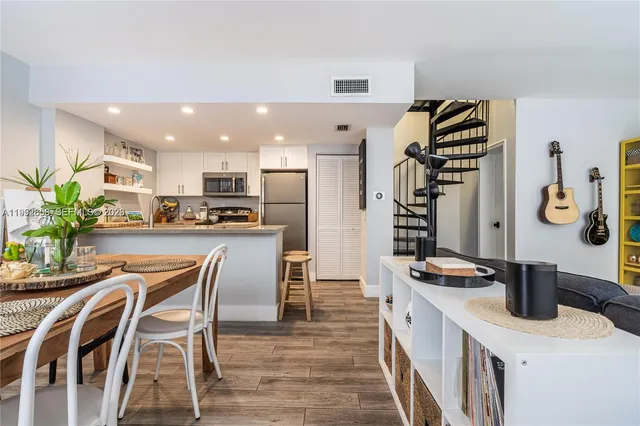 a kitchen with stainless steel appliances kitchen island granite countertop a sink and cabinets