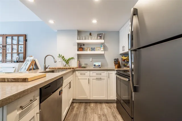 a kitchen with a sink and refrigerator