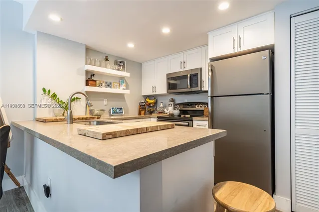 a kitchen with a refrigerator a sink and a stove