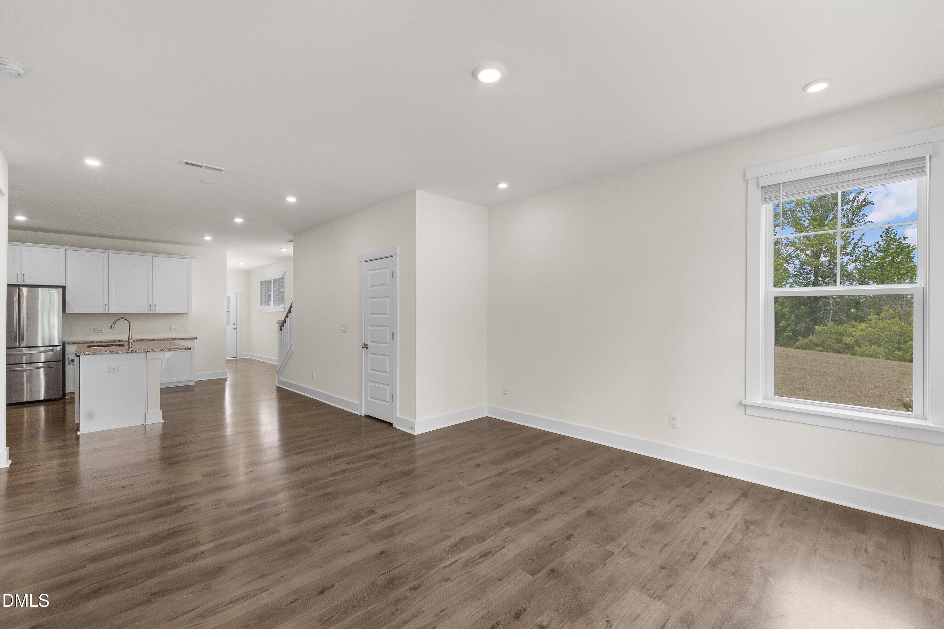 156 Sears Ridge Lane Morrisville, NC 27560 - Photo 14 of 49 an empty room with wooden floor and windows