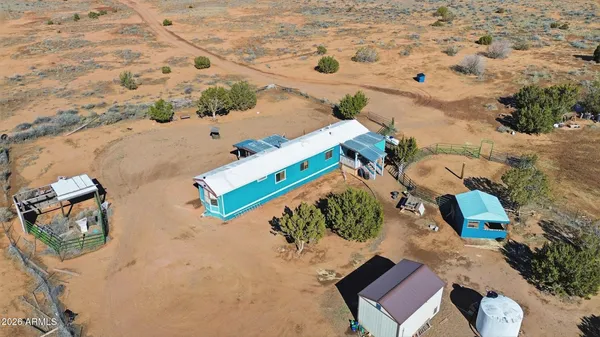 an aerial view of a house with a yard