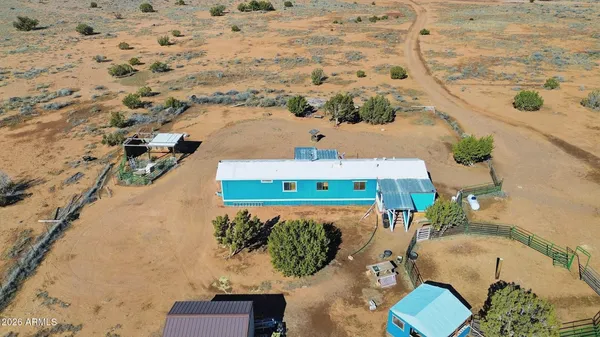 an aerial view of a house with a yard and lake view