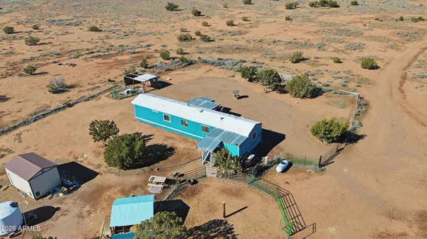 an aerial view of a house with a yard