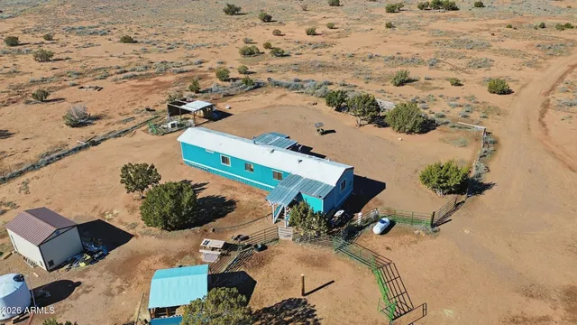 an aerial view of a house with a yard
