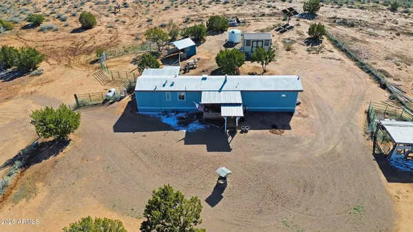 an aerial view of a house with a yard